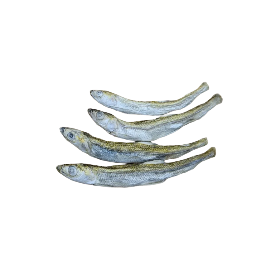 Four small, **Wild Nosh Pets Freeze-dried Smelt 1oz** laid out in a line on a wooden cutting board, showcasing a sustainable seafood option rich in Omega-3 fatty acids.