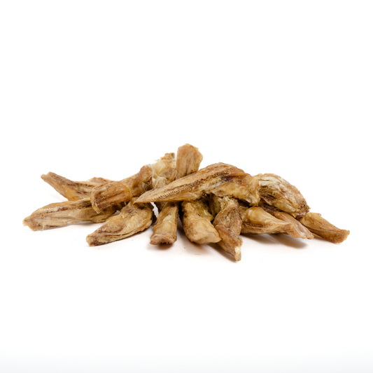 Freeze-Dried Duck Tongues 1 oz. by Wild Nosh Pets—light brown, protein-rich strips—are arranged in a small pile on a white background.