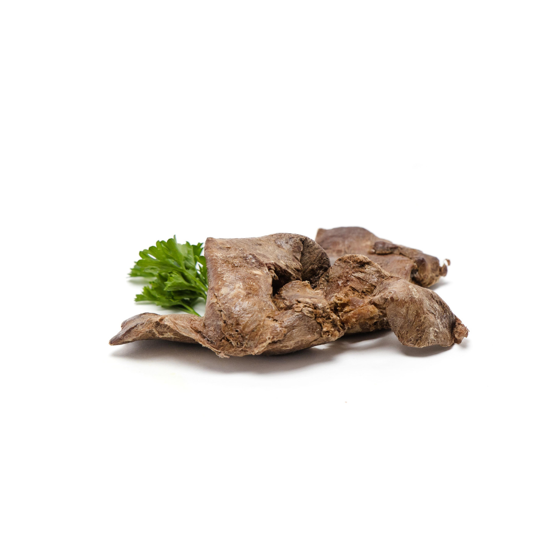 A Wild Nosh Pets Freeze-Dried Chicken Liver 3oz piece garnished with a sprig of parsley on a white background, showcasing its adherence to the Better Chicken Commitment.