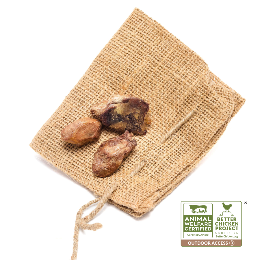 A burlap sack with Wild Nosh Pets Freeze-Dried Chicken Hearts 3oz on it. The sack displays "Animal Welfare Certified" and "Better Chicken Project" logos with "Outdoor Access" text, making it a nutritious treat for your beloved pets.