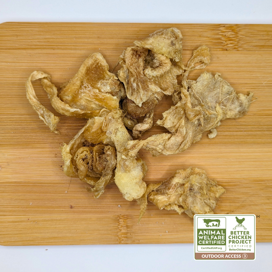 Freeze-Dried Chicken Collagen Chomps 3oz by Wild Nosh Pets on a wooden cutting board with a certification label indicating "Animal Welfare Certified," "Better Chicken Project," "Certified GAP Step 4," and "Outdoor Access," perfect for accompanying dishes featuring heritage breed chickens.