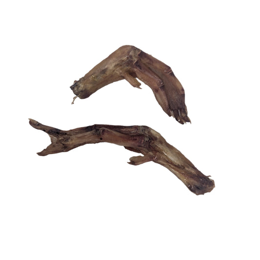 Two dehydrated duck feet from Wild Nosh Pets, rich in glucosamine, rest on a white surface.