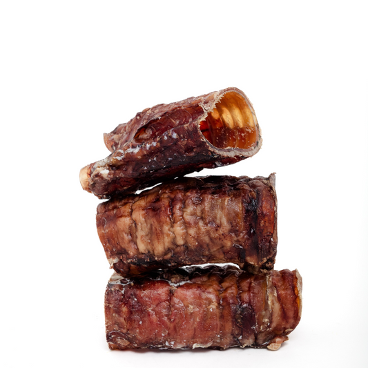 Three Wild Nosh Pets Bison Half Tracheas are stacked against a white background—wholesome dog chews that are naturally rich in glucosamine.