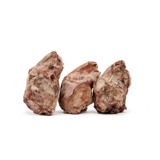 Three dried, brownish animal hooves with a rough texture and patches of fur, side by side on a white background, present an adventurous chew for pets. Freeze-Dried Rabbit Head from Wild Nosh Pets makes a nutritious crunchy snack that keeps them entertained and satisfied.