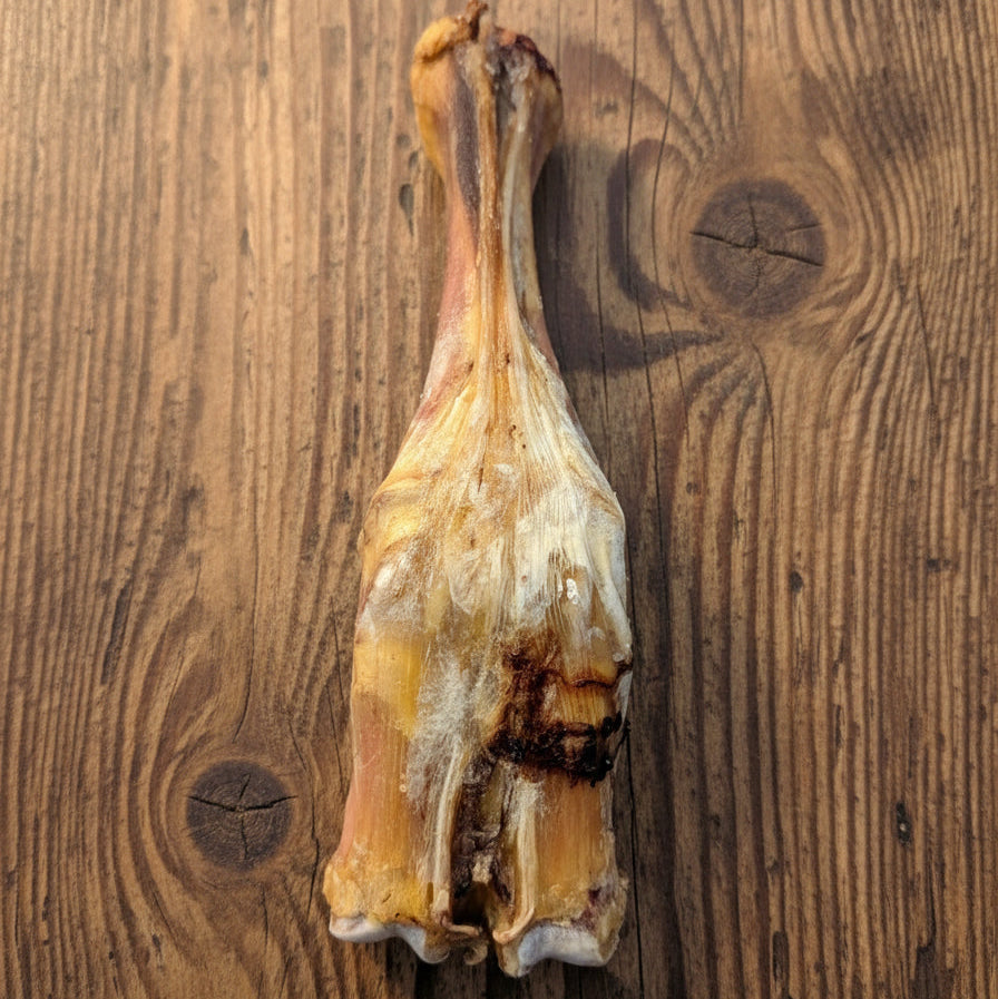 The Wild Nosh Pets Slow Roasted Bison Trotter Bone is a limited edition, 100% grass-finished dog chew featuring tendon and cartilage remnants for natural enjoyment.